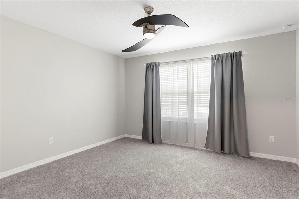 7537 Pool Compass Loop Wesley Chapel, FL 33545 - Photo 25 of 50 an empty room with windows