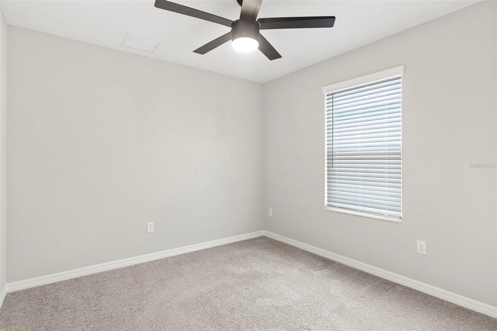 7537 Pool Compass Loop Wesley Chapel, FL 33545 - Photo 27 of 50 an empty room with a window and a fan