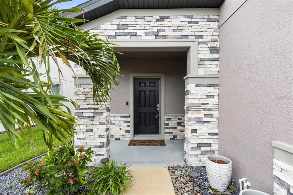 7537 Pool Compass Loop Wesley Chapel, FL 33545 - Photo 4 of 50 a front view of a house with a garden