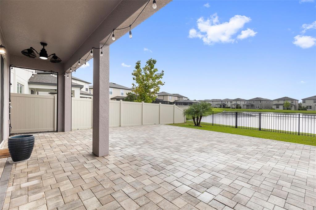 7537 Pool Compass Loop Wesley Chapel, FL 33545 - Photo 44 of 50 a view of a porch with a table and chairs