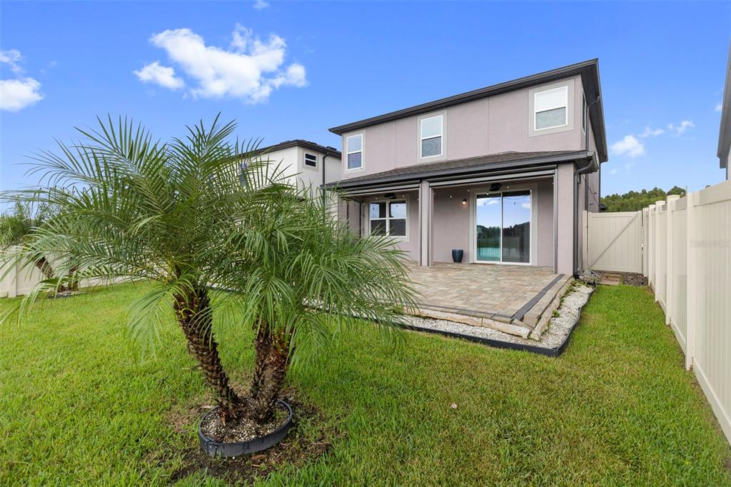 7537 Pool Compass Loop Wesley Chapel, FL 33545 - Photo 48 of 50 a view of a house with a yard