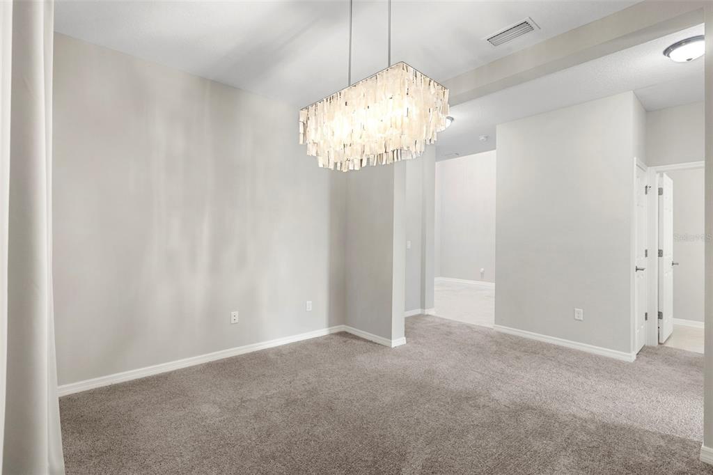 7537 Pool Compass Loop Wesley Chapel, FL 33545 - Photo 7 of 50 a view of a chandelier in a room