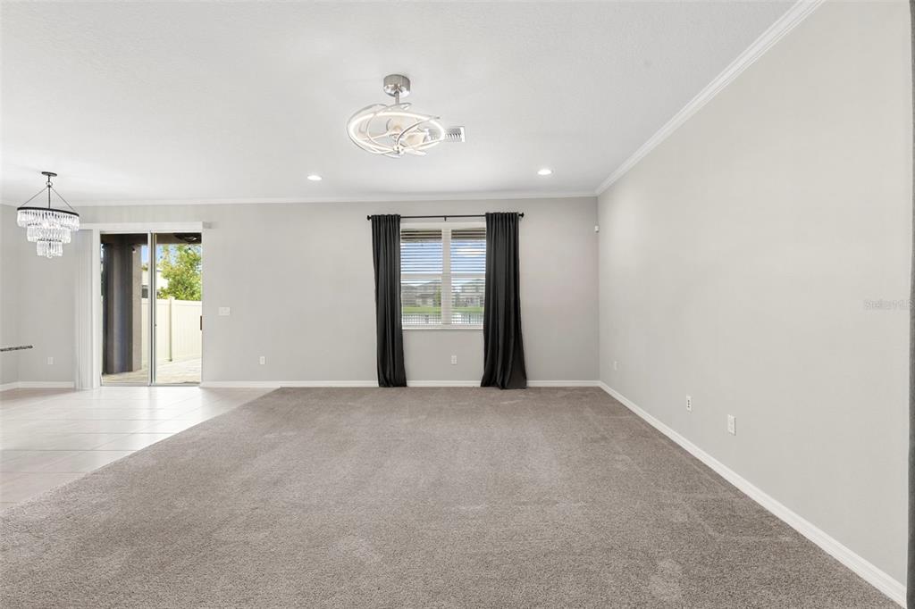 7537 Pool Compass Loop Wesley Chapel, FL 33545 - Photo 10 of 50 an empty room with windows and painted walls
