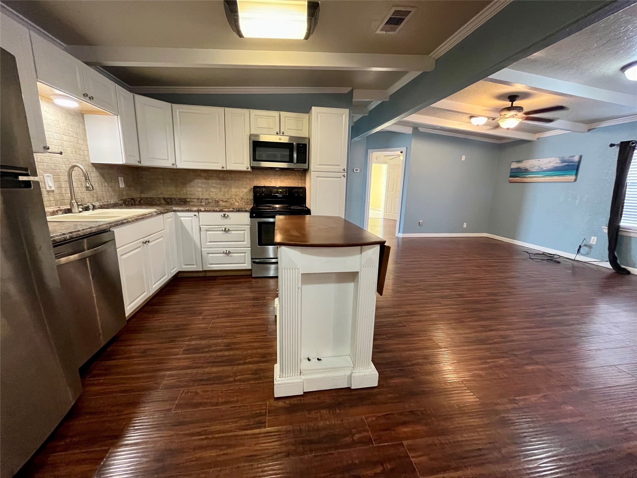 318 Marine Way Freeport, TX 77541 - Photo 3 of 20 a kitchen with stainless steel appliances granite countertop a refrigerator a sink dishwasher a stove and white countertops with wooden floor