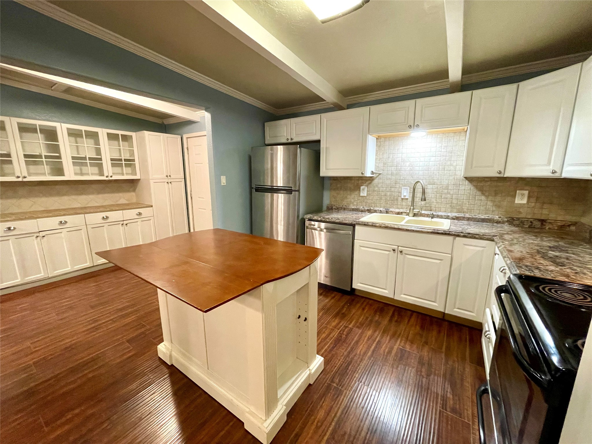 318 Marine Way Freeport, TX 77541 - Photo 10 of 20 a kitchen with stainless steel appliances hardwood floor sink stove and wooden cabinets