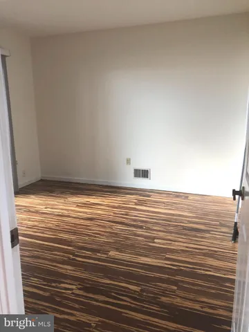 a view of room with wooden floor