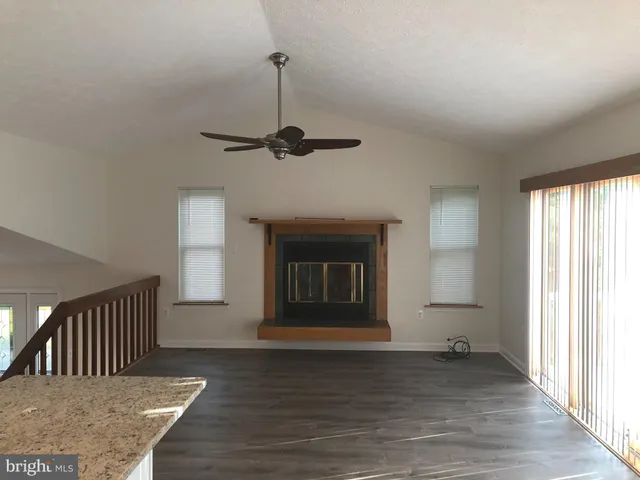 a view of a livingroom with a fireplace and window
