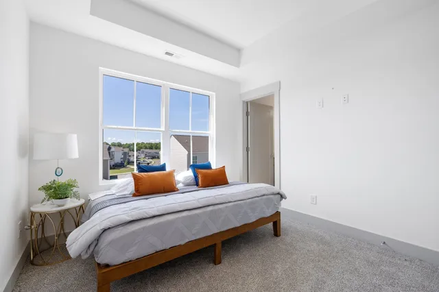 a bedroom with furniture and a potted plant