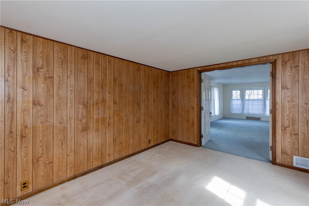 1050 Renfield Road Cleveland Heights, OH 44121 - Photo 17 of 41 Family room featuring light carpet and wood walls