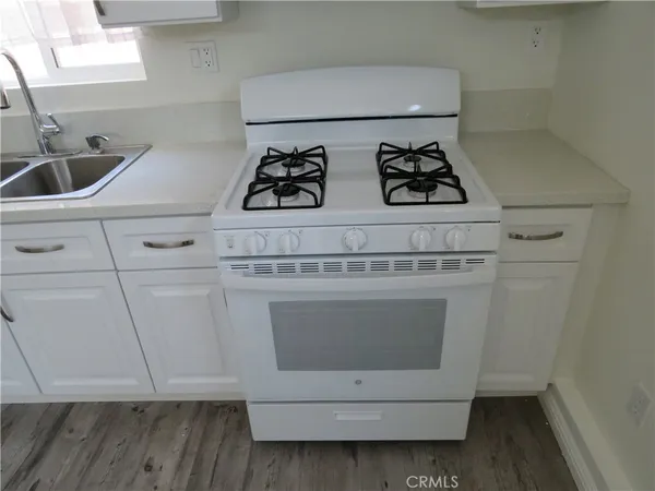 a stove top oven sitting inside of a kitchen