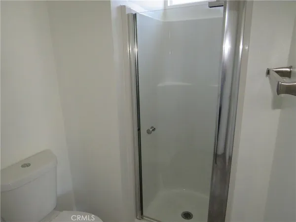 a bathroom with a glass shower door