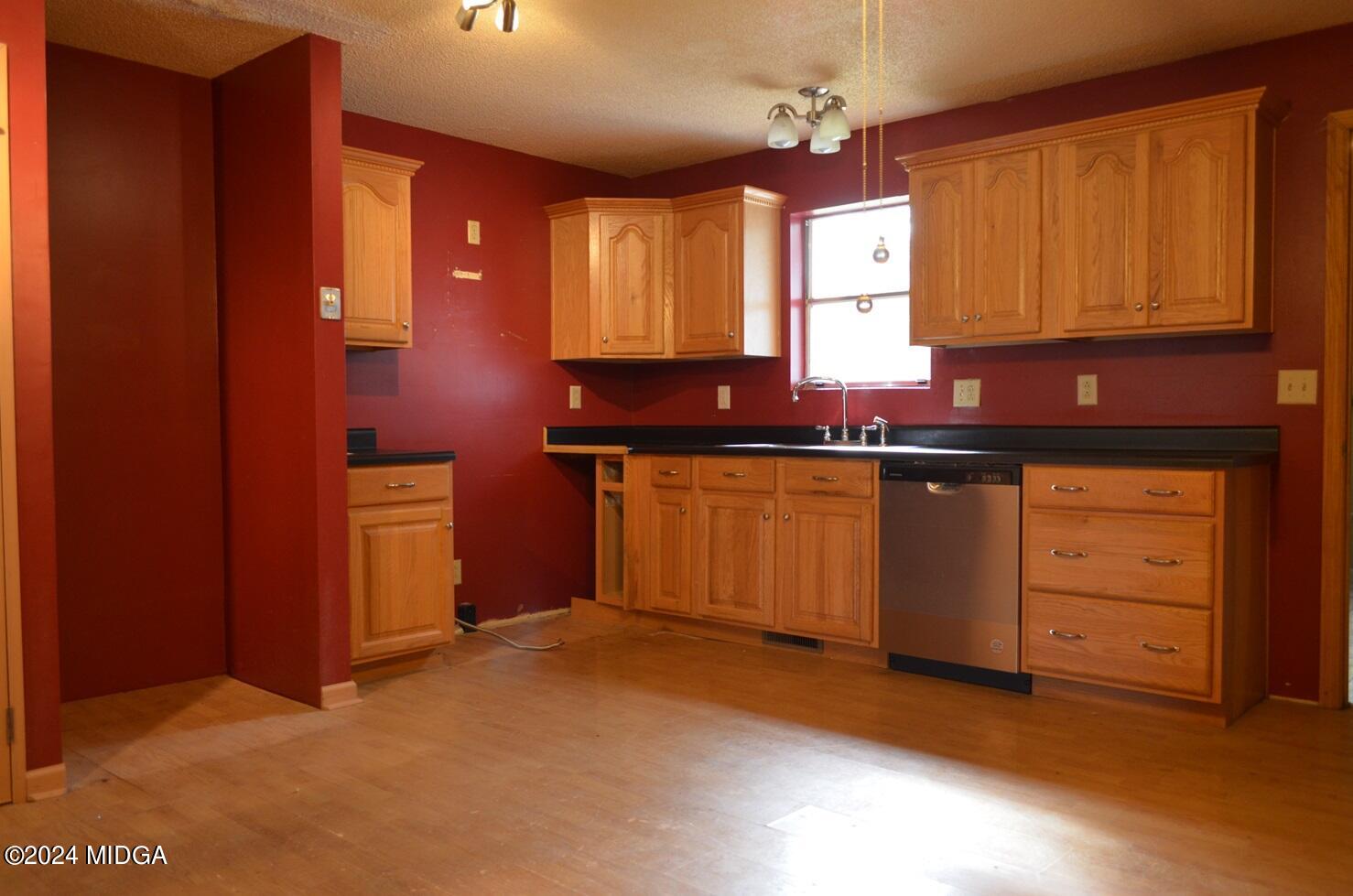 3910 Thompson Road Macon, GA 31204 - Photo 7 of 16 a view of a kitchen with granite countertop cabinets and wooden floor