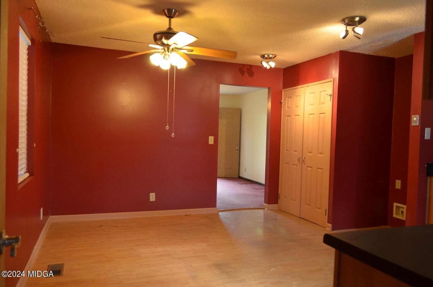 3910 Thompson Road Macon, GA 31204 - Photo 8 of 16 en empty room with windows and fan