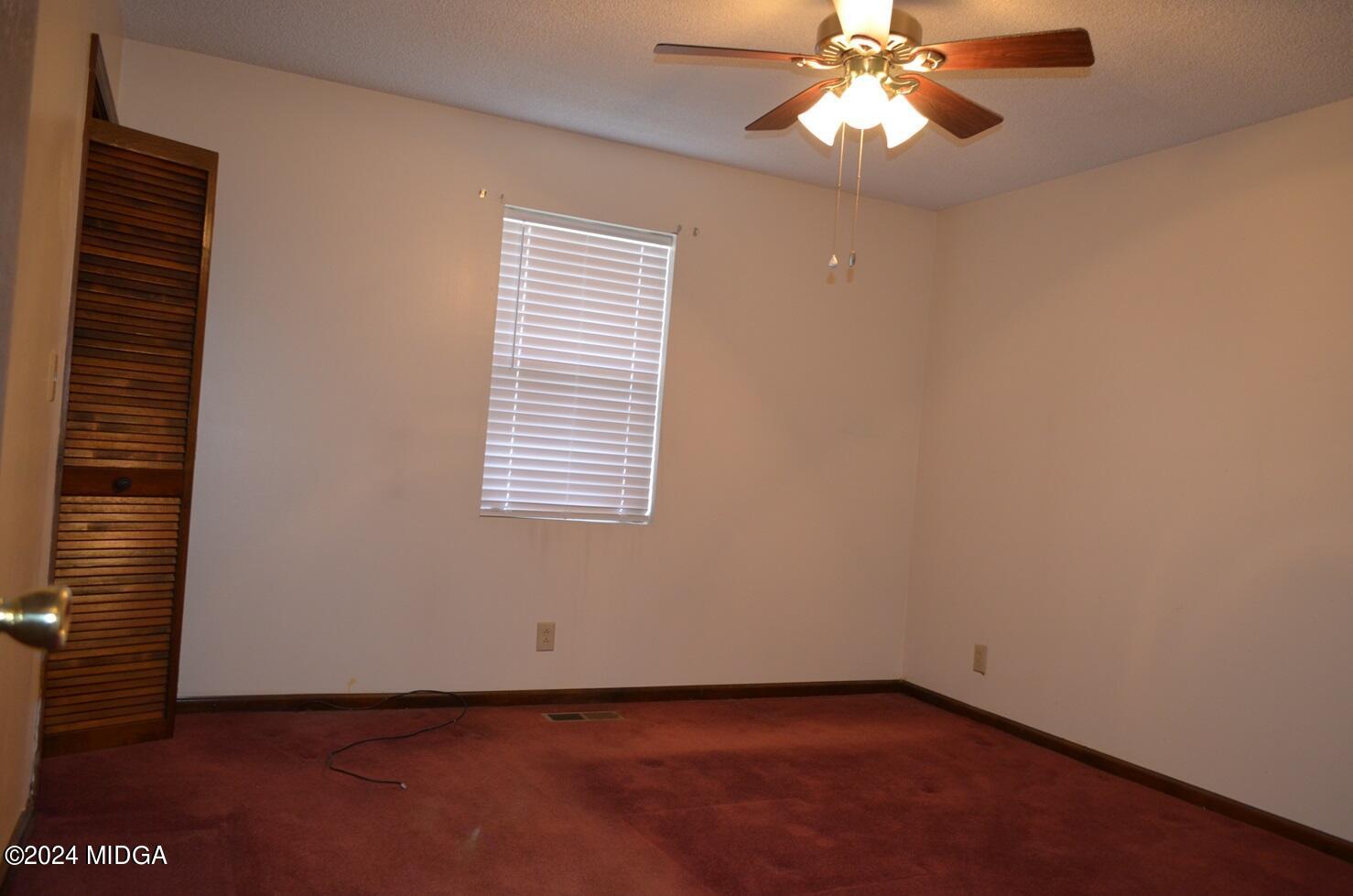 3910 Thompson Road Macon, GA 31204 - Photo 10 of 16 an empty room with windows and fan