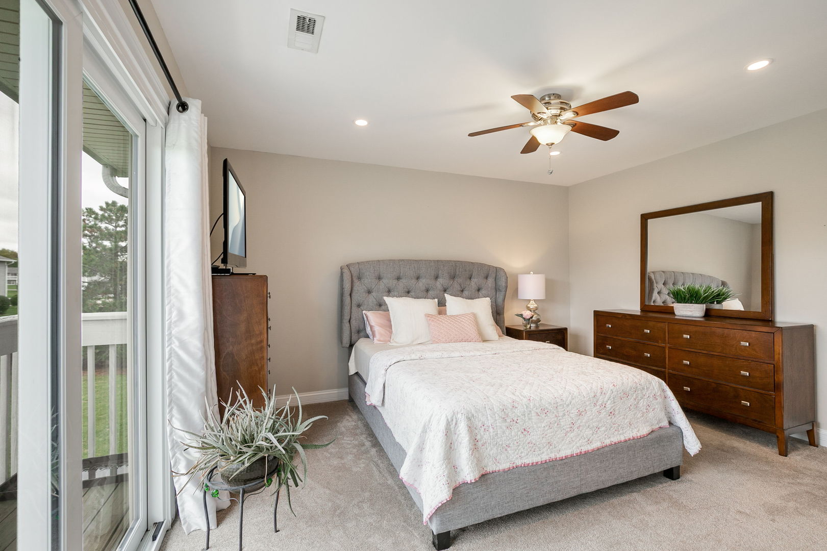 17438 Walnut Lane Gurnee, IL 60031 - Photo 8 of 17 a bedroom with a large bed and a chandelier