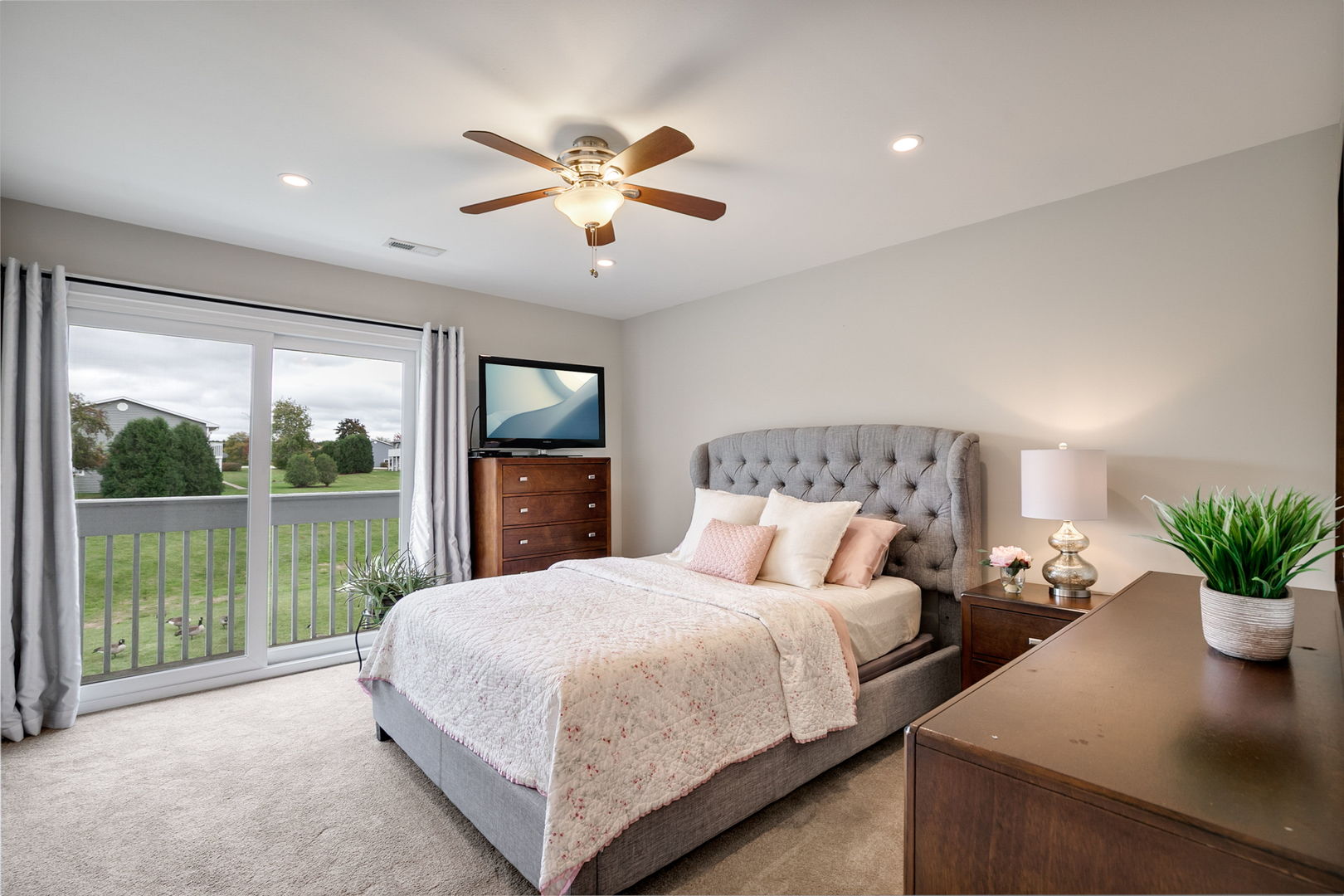 17438 Walnut Lane Gurnee, IL 60031 - Photo 9 of 17 a bedroom with a large bed and a chandelier