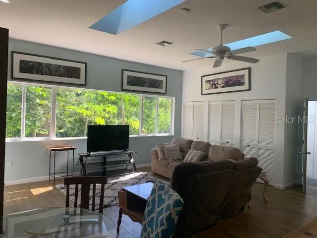 a view of a balcony with two chairs and a potted plant