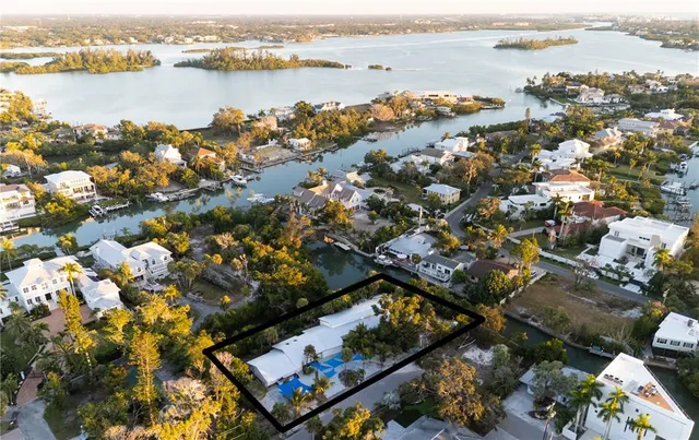 an aerial view of a house with a yard and lake view