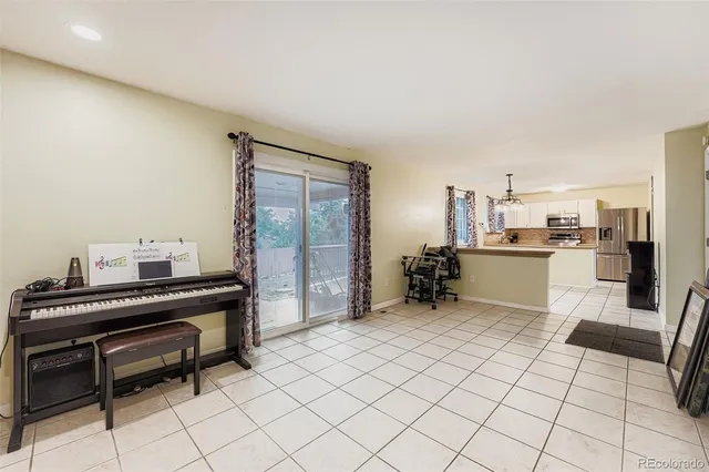 a room with furniture a piano and wooden floor