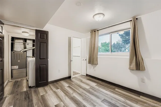 a view of a room with wooden floor and a window