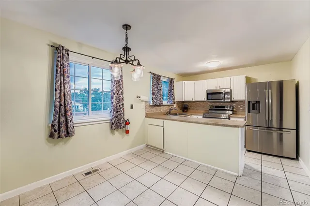 a kitchen with a refrigerator a sink and dishwasher