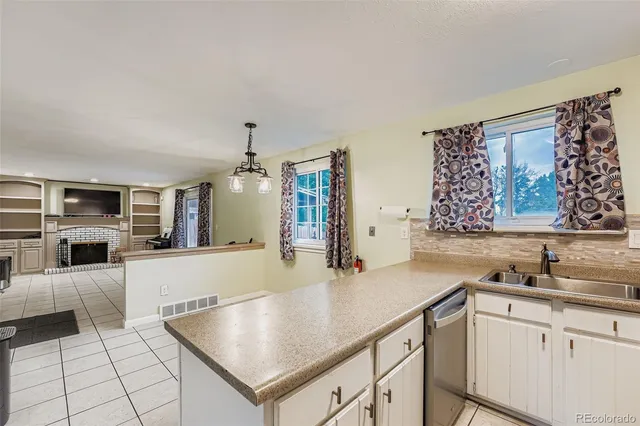 a kitchen with stainless steel appliances granite countertop a sink and white cabinets