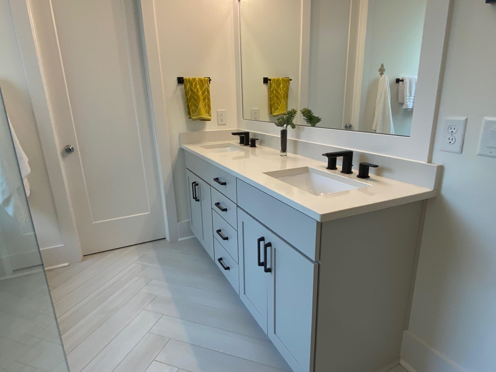 4408 Duraleigh Road Raleigh, NC 27612 - Photo 12 of 21 a bathroom with a double vanity sink and mirror