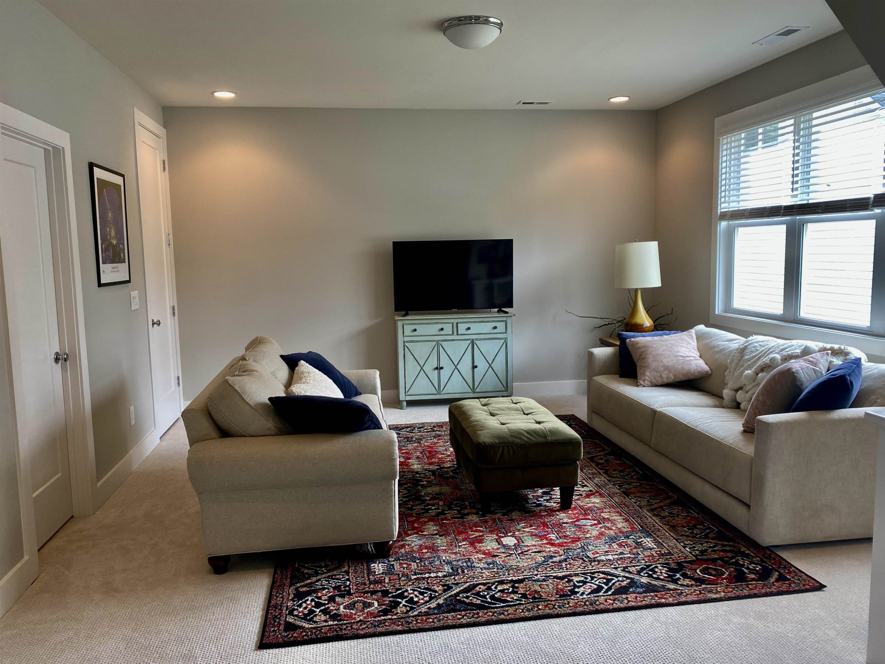 4408 Duraleigh Road Raleigh, NC 27612 - Photo 18 of 21 a living room with furniture a window and a flat screen tv