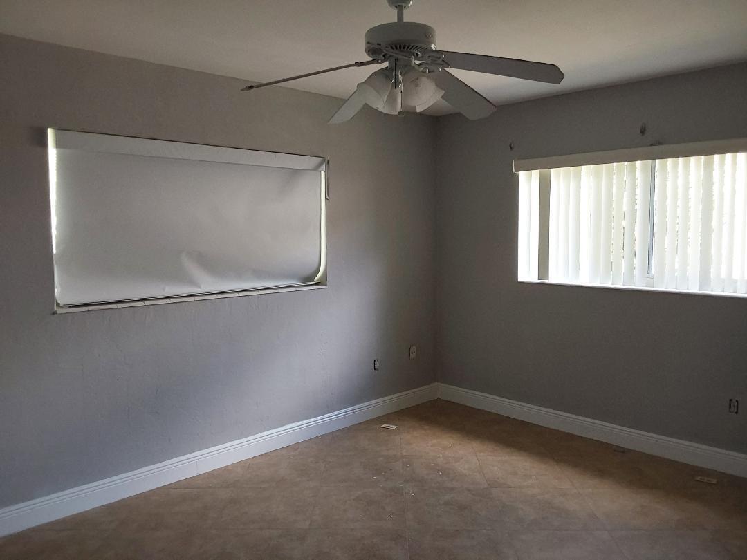 98 Seminole Lane Boca Raton, FL 33487 - Photo 29 of 42 an empty room with a window and a fan