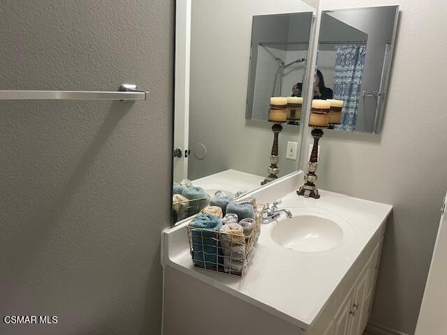 1256 Patricia Avenue, Unit 10 Simi Valley, CA 93065 - Photo 17 of 25 a bathroom with a sink a toilet and mirror