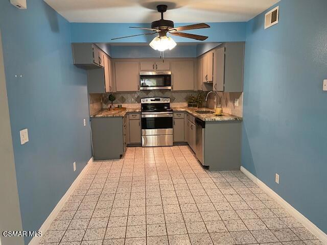 1256 Patricia Avenue, Unit 10 Simi Valley, CA 93065 - Photo 22 of 25 a kitchen with stainless steel appliances granite countertop a stove a sink and a refrigerator