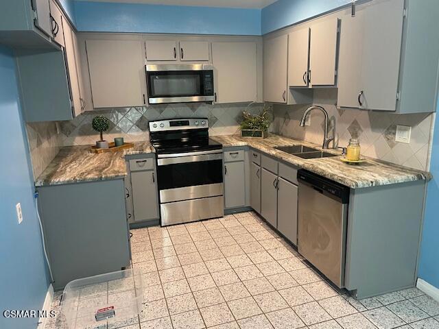 1256 Patricia Avenue, Unit 10 Simi Valley, CA 93065 - Photo 6 of 25 a kitchen with a sink stove and microwave