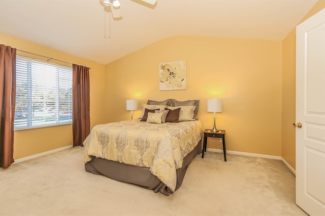 302 Locksley Drive Streamwood, IL 60107 - Photo 16 of 23 a spacious bedroom with a bed and a window
