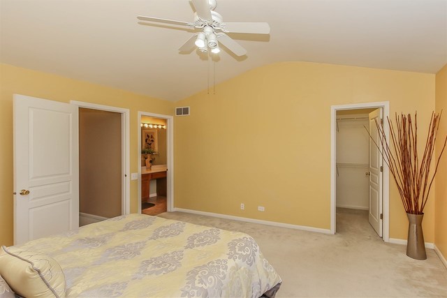 302 Locksley Drive Streamwood, IL 60107 - Photo 17 of 23 a bedroom with a bed and a chandelier