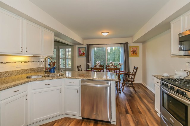 302 Locksley Drive Streamwood, IL 60107 - Photo 9 of 23 a kitchen with white cabinets and appliances