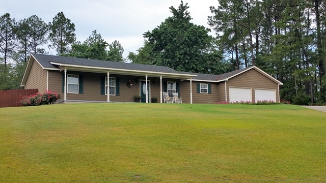 a front view of house with yard and green space