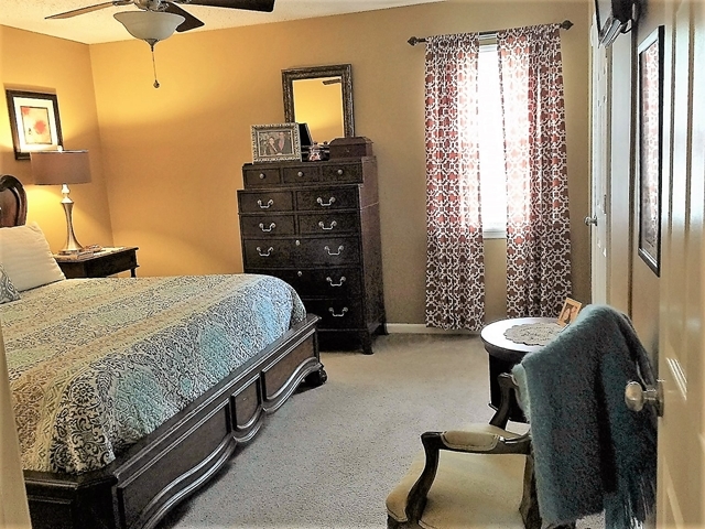 4967 Fulton Mill Road Macon, GA 31216 - Photo 14 of 28 a bedroom with a bed and a chandelier