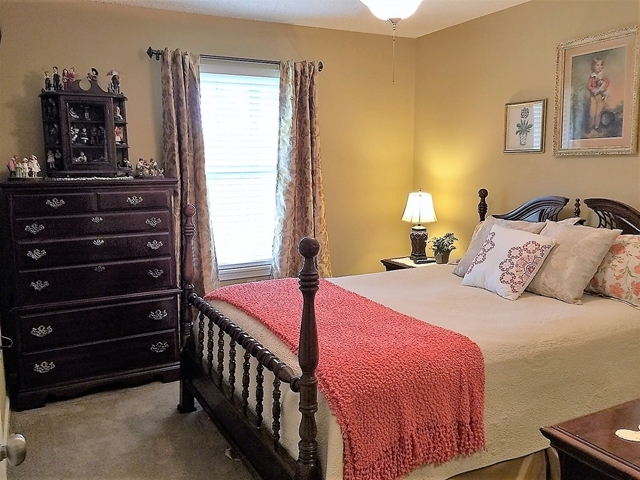 4967 Fulton Mill Road Macon, GA 31216 - Photo 17 of 28 a bedroom with a bed and a mirror