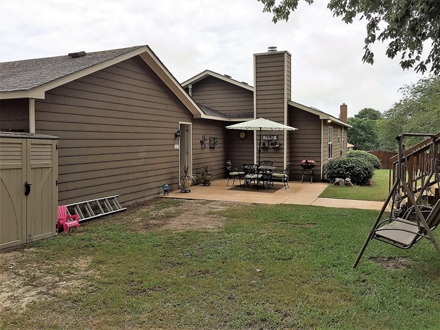 4967 Fulton Mill Road Macon, GA 31216 - Photo 23 of 28 a backyard of a house with barbeque oven table and chairs