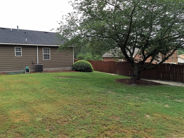 4967 Fulton Mill Road Macon, GA 31216 - Photo 24 of 28 a view of a house with a yard and a large tree