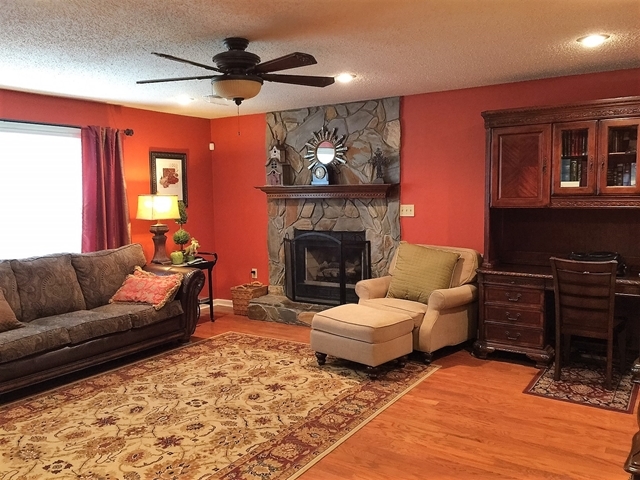 4967 Fulton Mill Road Macon, GA 31216 - Photo 4 of 28 a living room with furniture and a fireplace