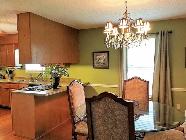 4967 Fulton Mill Road Macon, GA 31216 - Photo 7 of 28 a dining room with furniture and chandelier