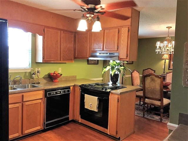 4967 Fulton Mill Road Macon, GA 31216 - Photo 9 of 28 a kitchen with stainless steel appliances granite countertop a stove a sink and a microwave