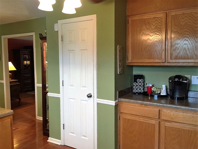 4967 Fulton Mill Road Macon, GA 31216 - Photo 10 of 28 a kitchen with a refrigerator and cabinets
