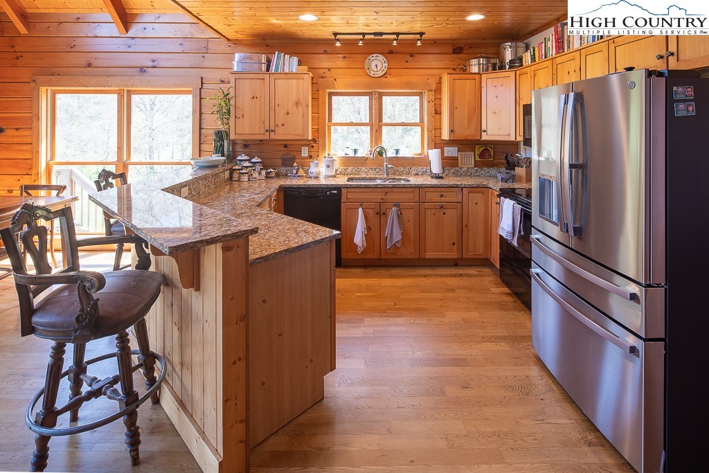 154 Lilac Lane Boone, NC 28607 - Photo 19 of 50 a kitchen with stainless steel appliances granite countertop a stove a refrigerator and a dining table