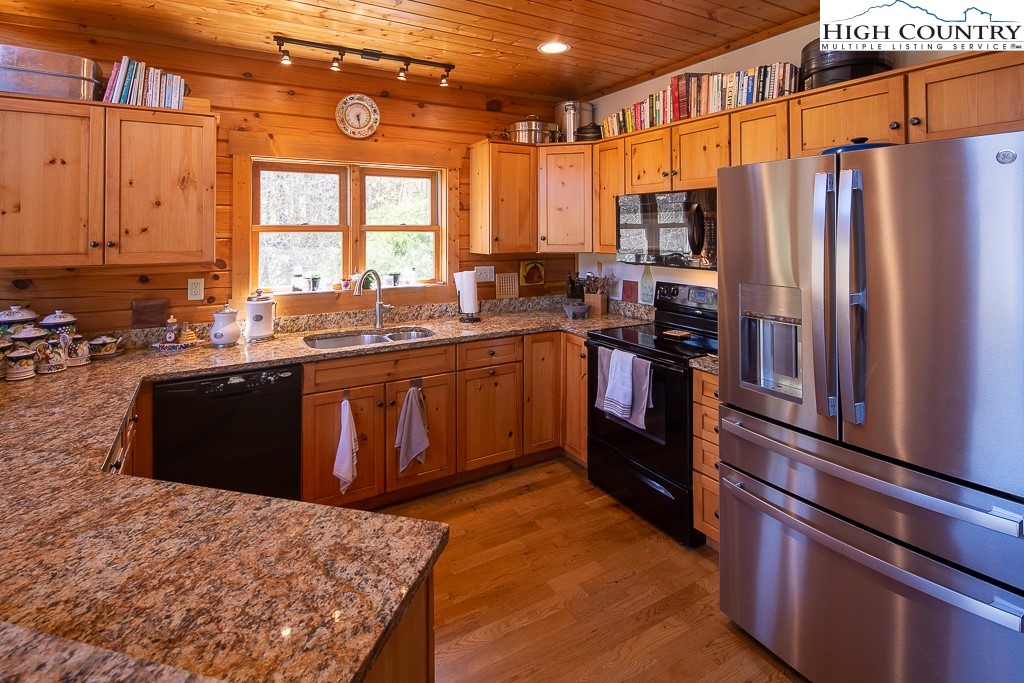 154 Lilac Lane Boone, NC 28607 - Photo 20 of 50 a kitchen with stainless steel appliances granite countertop a stove a sink and a refrigerator