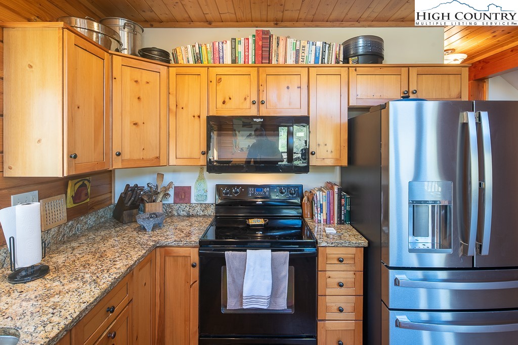154 Lilac Lane Boone, NC 28607 - Photo 21 of 50 a kitchen with stainless steel appliances granite countertop a stove and a refrigerator