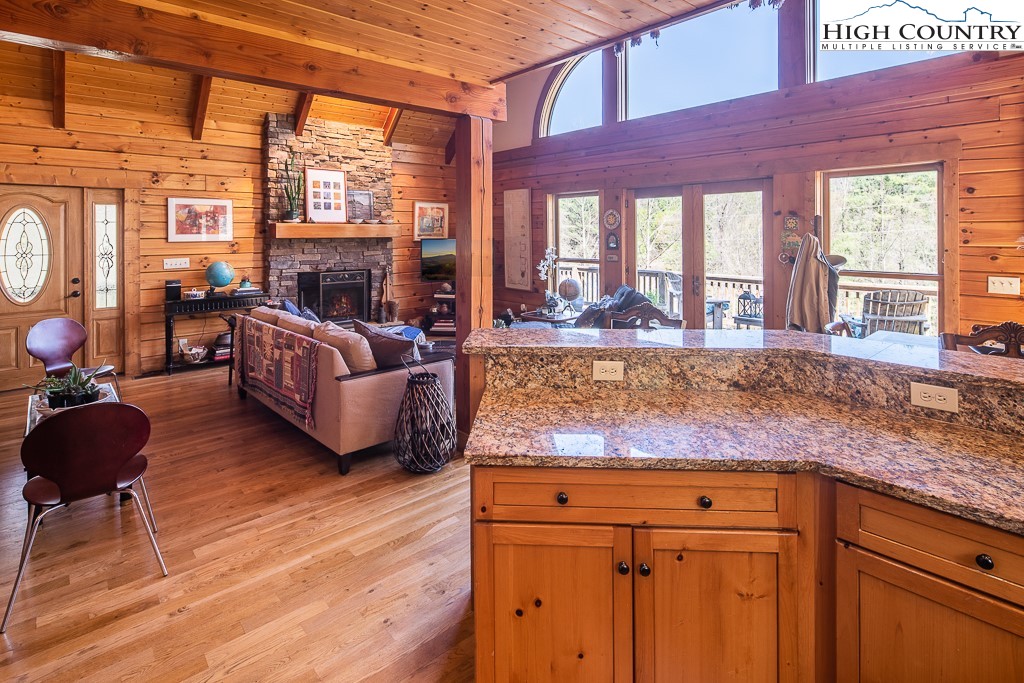 154 Lilac Lane Boone, NC 28607 - Photo 22 of 50 a living room with granite countertop couches a fireplace with wooden floor