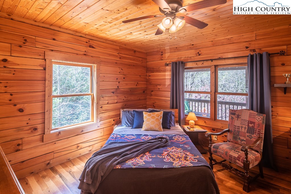 154 Lilac Lane Boone, NC 28607 - Photo 23 of 50 a bedroom with a bed and wooden floor