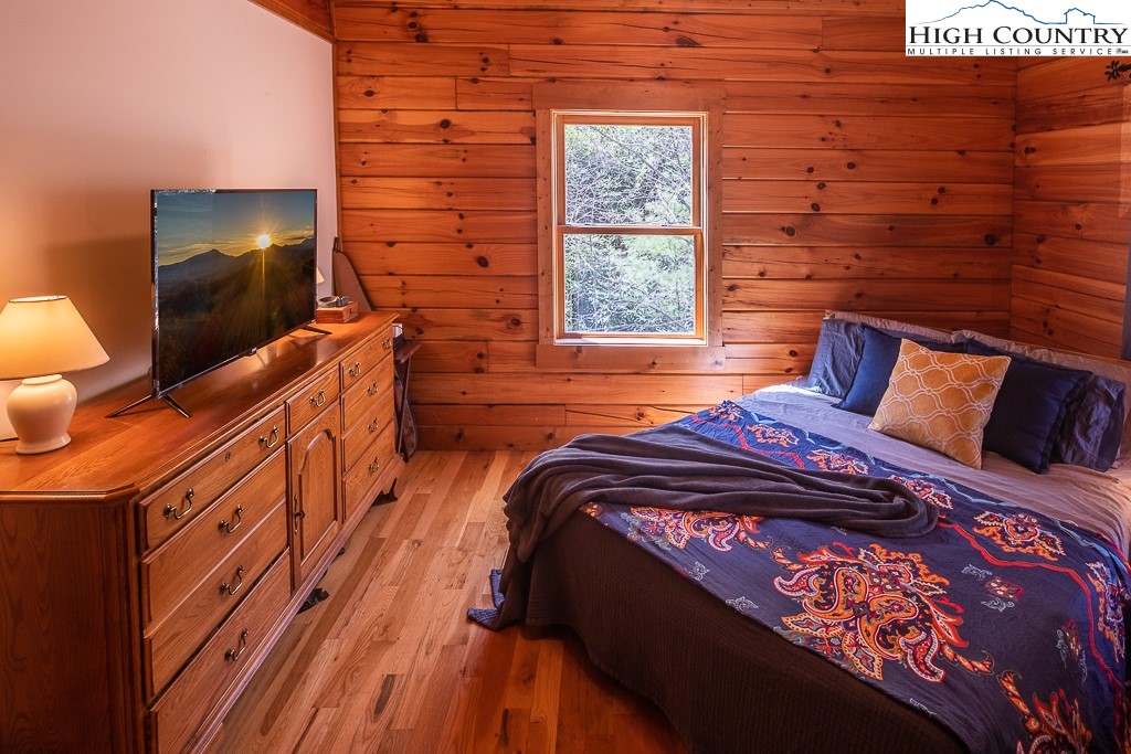 154 Lilac Lane Boone, NC 28607 - Photo 24 of 50 a bedroom with a bed and a flat screen tv